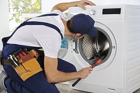 Technician repairing a washing machine