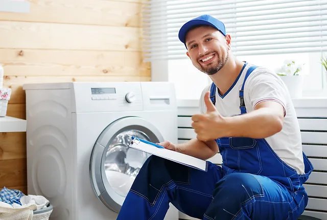 Technician with a clipboard beside a laundry appliance